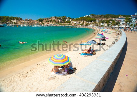 Colorful umbrellas on Puerto de Soller, Port of Mallorca island in balearic islands, Spain. Beautiful picture of people resting on the beach on bright summer day.