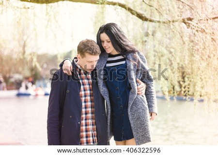 Love story. Beautiful young loving couple embracing in blossom spring garden. Romantic dating. Spring outdoor.