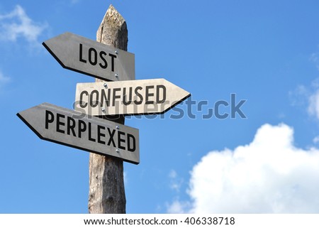 "Lost, confused, perplexed" - wooden signpost, cloudy sky Royalty-Free Stock Photo #406338718