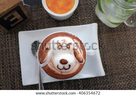 Hot chocolate with latte art in white cup on the table

