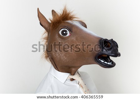 Businessman closeup portrait wearing horse head Royalty-Free Stock Photo #406365559