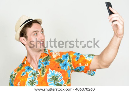 Tourist man taking selfie with mobile phone