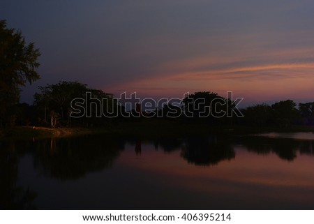 Abstract background from silhouette un focus image view of colorful sky reflex water in evening :ideal use for background.