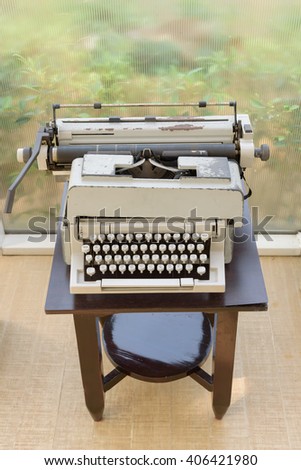 vintage typewriter with thai letter on wood desk 