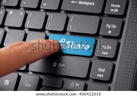 Close up shot of a finger clicking the SHARE button on a laptop keyboard Royalty-Free Stock Photo #406422616