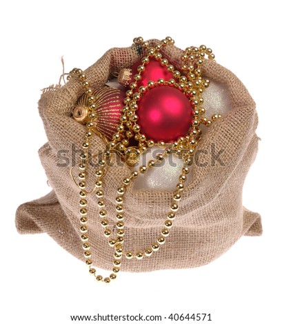 Santa's bagsack with christmas gifts and treasure. Not isolated, just shot on white