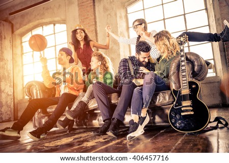 Mixed race group of teenagers having fun on the couch Royalty-Free Stock Photo #406457716