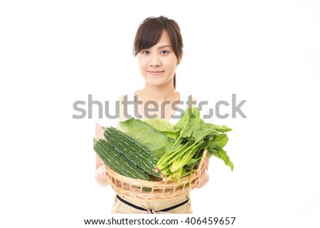 Asian woman holding vegetables