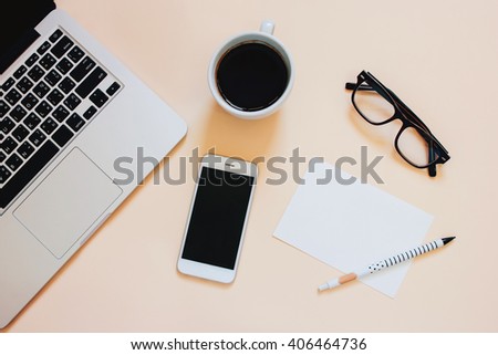 Creative flat lay photo of workspace desk with laptop, smartphone, coffee and blank paper with copy space background, minimal style
