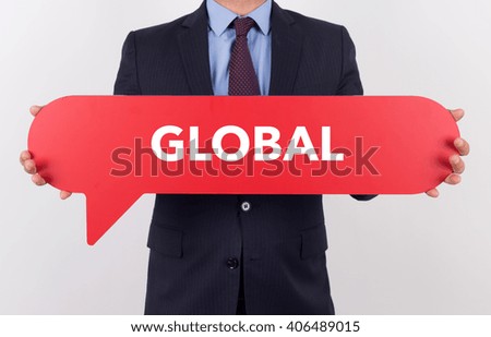 Businessman holding speech bubble with a word GLOBAL