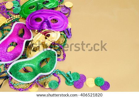 Vibrant Mardi Gras background with masks, beads and coins and copy space