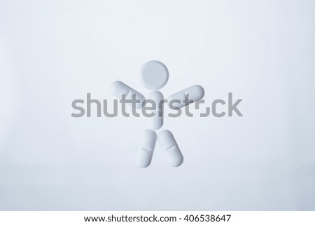Human character made out of white pills isolated on light background