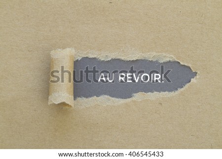 French word AU REVOIR (goodbye) written under torn paper.