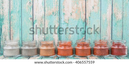 Assortment of hot and spicy spices powder in small mason jar over wooden background