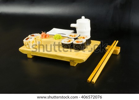 Sushi roll set the board on a black background