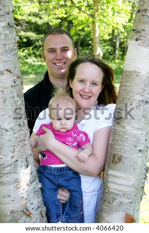 Young family together in trees on spring day