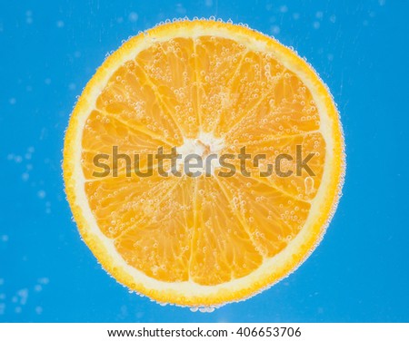 Orange cocktail , in soda water ,against  blue background