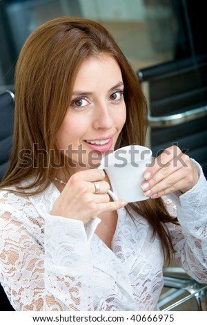business woman portrait drinking coffee in an office
