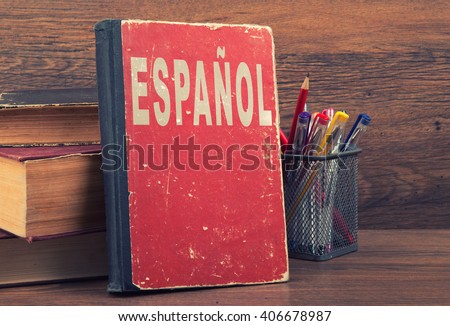 learn spanish concept. book on a wooden background Royalty-Free Stock Photo #406678987