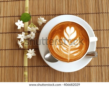 Hot latte art coffee on brown background