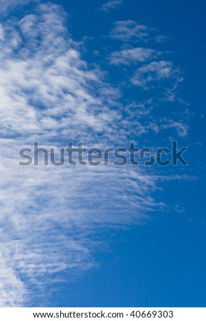 Fleecy clouds against a background blue sky
