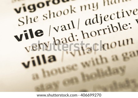 Close up of old English dictionary page with word vile