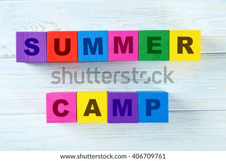 Colorful wooden toy cubes on a blue wooden background