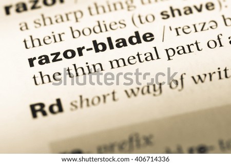 Close up of old English dictionary page with word razor blade