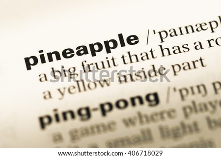 Close up of old English dictionary page with word pineapple