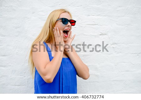 Beautiful young woman watching movie with 3D glasses, exciting holding hands. Closeup portrait
