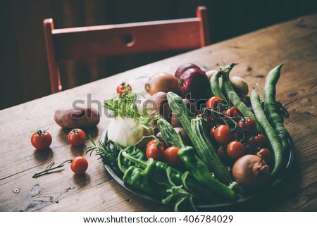 Different fresh farm vegetables on wooden table. Autumn harvest and healthy organic food concept. Toned picture