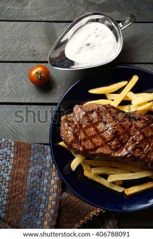 Grilled steak with french fries and salt, closeup