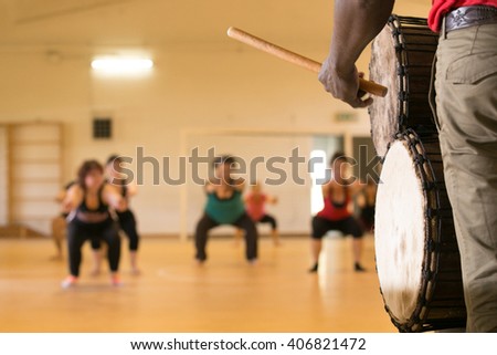 Close up of traditional African drum, view from rear, dance class in background