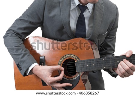 Businessman playing acoustic guitar isolated on white background.