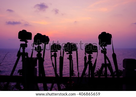 Siihouette 6 cameras on sunset seascape background