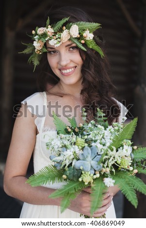 Portrait of beautiful bride with green flowers.