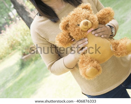 woman holding teddy bear