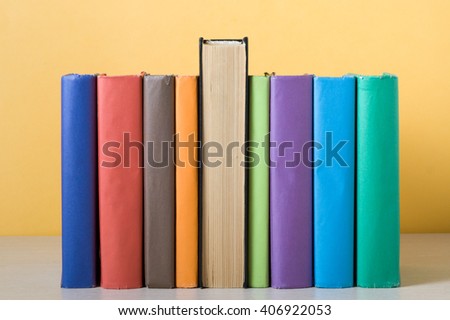 Stack of colorful books on table. Education background. Back to school. Copy space for text.