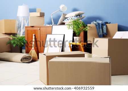 Packed household goods for moving into new house Royalty-Free Stock Photo #406932559