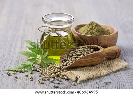 Hemp oil n a glass jar and hemp seeds Royalty-Free Stock Photo #406964995