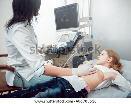 Doctor and little girl patient. Ultrasound equipment. Diagnostics. Sonography.