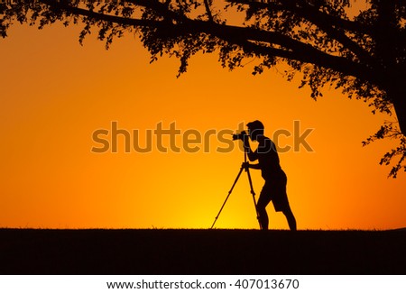 Man shooting a camera in a beautiful natural setting. 