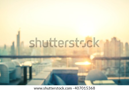 Rooftop party concept: Blurred dining table restaurant with beautiful city view at twilight scene background. Bangkok, Thailand, Asia