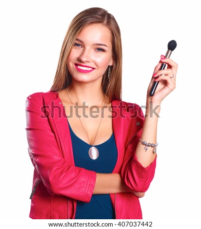 Young beautiful woman holds in hand brush for makeup