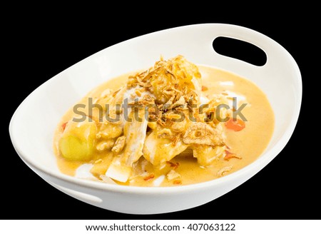 thai massaman curry chicken or peanut curry with chicken served with potatoes and crispy shallot on top