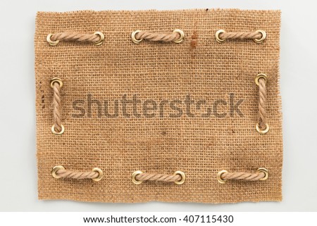 Frame of burlap, lies on a white background, can be used as texture Royalty-Free Stock Photo #407115430