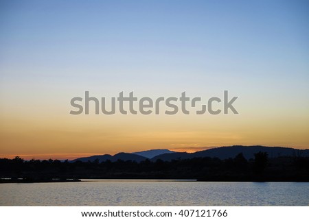 Beautiful sky, lake and hill at sunset