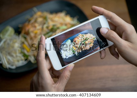 Woman hands taking food photo by mobile phone 