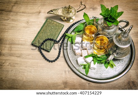 Tea glasses and pot. Oriental hospitality concept. Islamic holidays decoration. Ramadan kareem. Eid mubarak. Vintage style toned picture