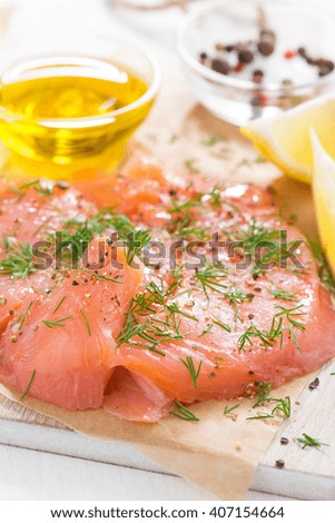 salted salmon with dill on a wooden board, close-up, vertical